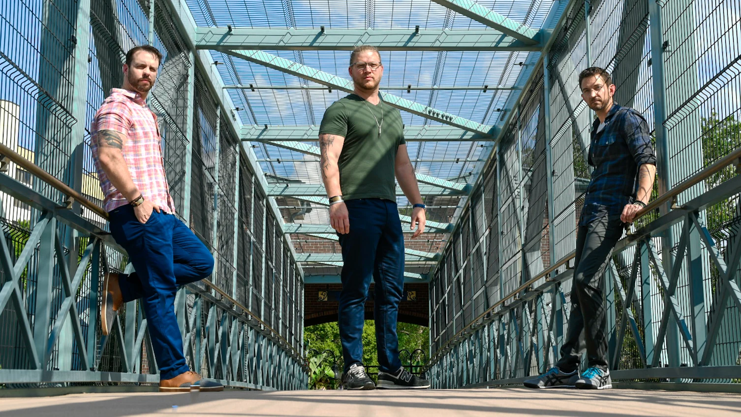 Cypress Fyre on a steel walkway, with Chris, Jeff, and Tyler standing across the frame