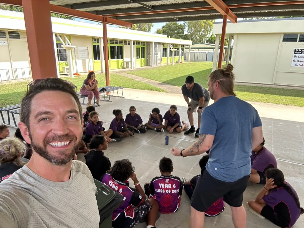 Cypress Fyre facilitating a music workshop with students in an outdoor learning space
