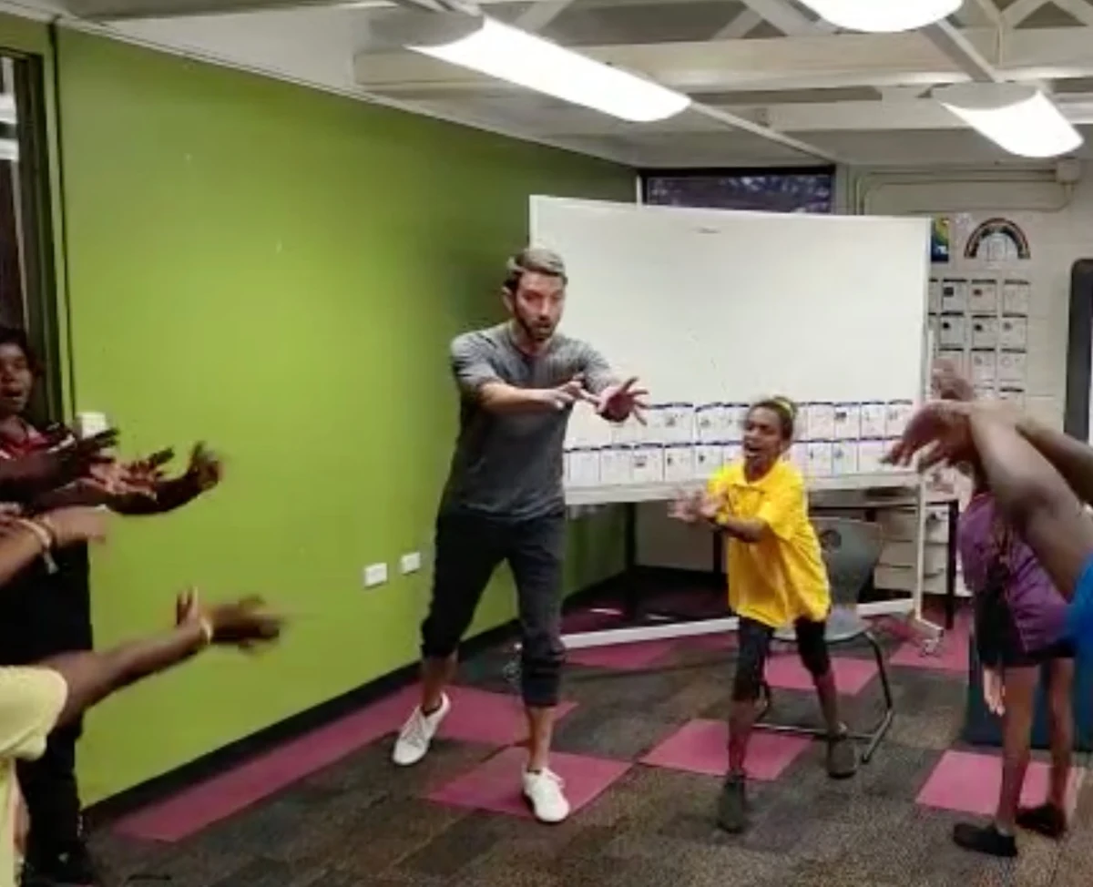Jeff Grider leading a movement activity with students in a classroom